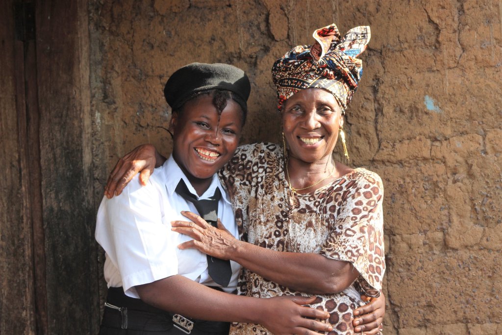 Fatmata, hugs her mom. Their relationship deteriorated when Fatmata became pregnant at 15, but now, Fatmata has her family's support. 