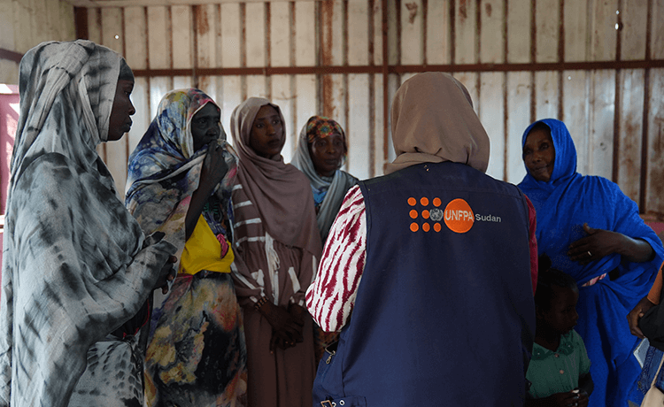 Women talk in a group in Sudan