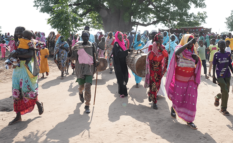 Residents in the Shanisha community in Sudan’s Blue Nile State celebrate the installation of a new village flour mill.