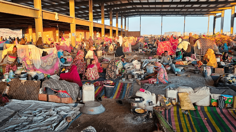 People, including new mothers and pregnant women, crowd a displacement camp in Sudan.