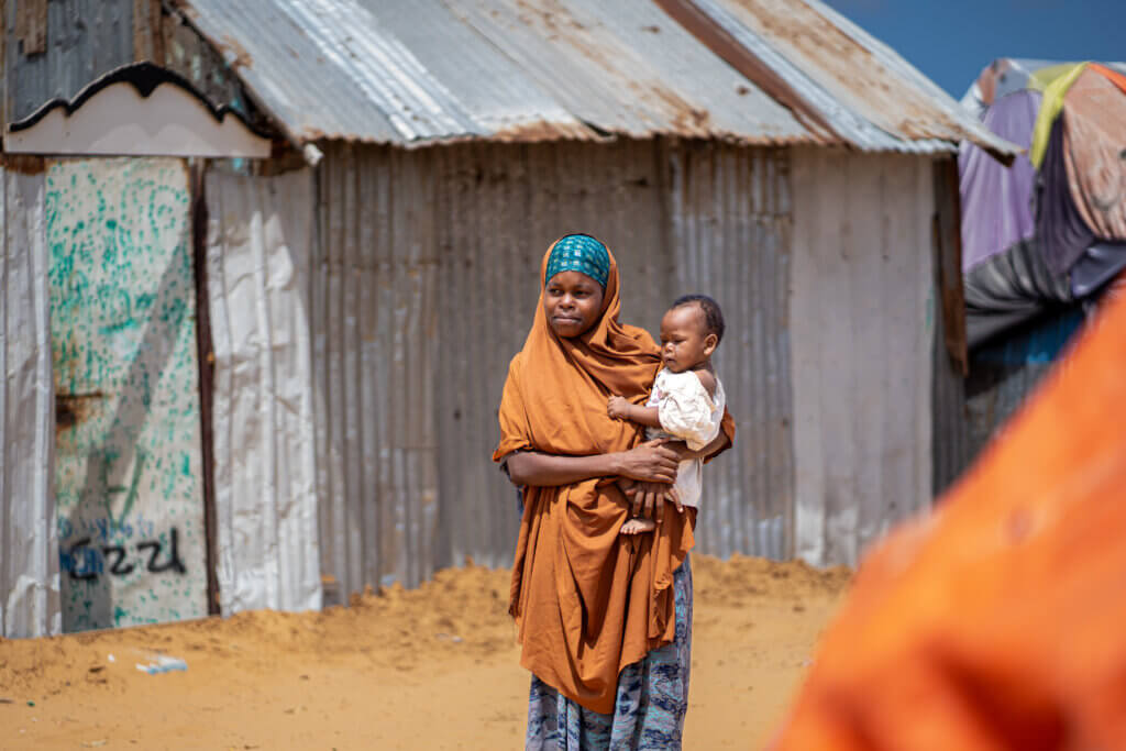 A mother holds her baby in a displacement camp in Somalia