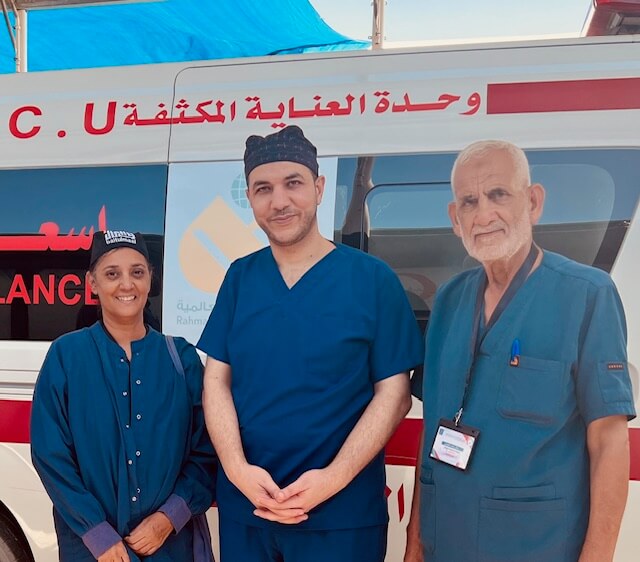 Dr. Sleemi (left) standing in front of an ambulance in Gaza