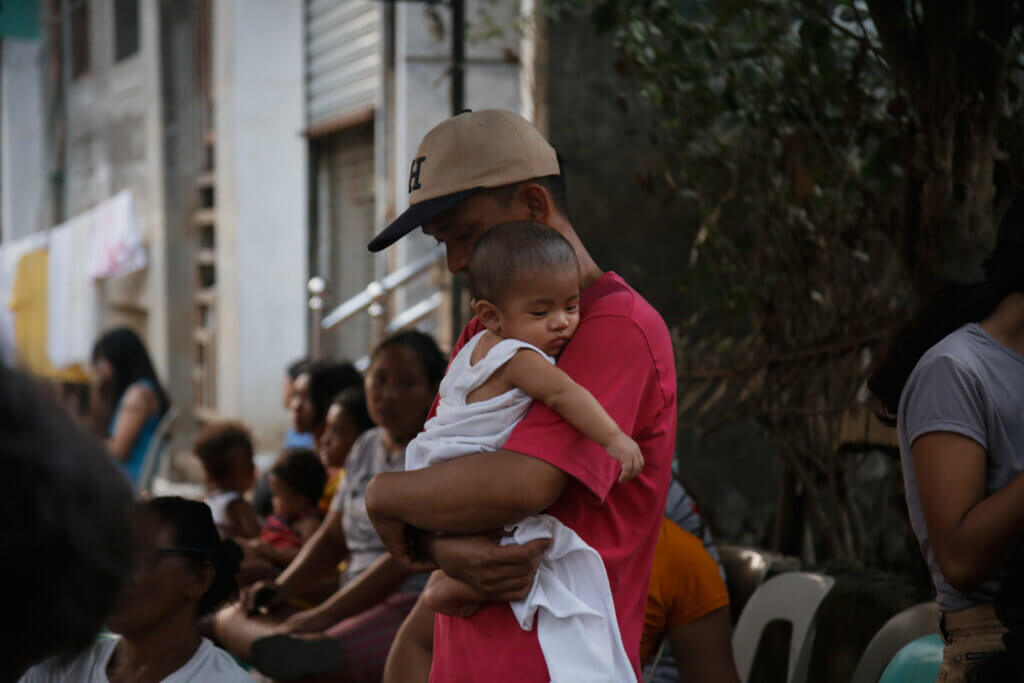 A father caring for his son after a typhoon. UNFPA Philippines 