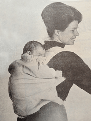 Patent diagram of a soft fabric carrier worn on an adult's chest to hold an infant.